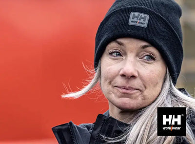 Black beanie with white logo, hh workwear brand.