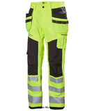 Yellow Helly Hansen Hi Viz Alna 2.0 Stretch Construction trouser Class 2-77423 Hi Vis Trousers Active-Workwear With stretch fabric, heat transfer reflectives and great fit the Alna Construction pant 2.0 will keep you safe and visible. The hanging pockets make sure you can quickly access the tools you need to get the job done.