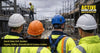 UK construction workers wearing different hard hat types including cap style, full brim, chin strap helmet and non-vented helmet on site