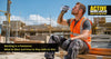 Construction worker taking a water break on a hot summer building site wearing hi-vis vest and work trousers