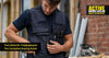 Tradesperson wearing a multi-pocket tool vest on a construction site