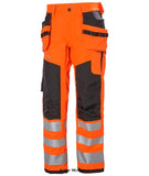Helly Hansen Hi Viz Alna 2.0 Stretch Construction trouser Class 2-77423 Hi Vis Trousers Active-Workwear With stretch fabric, heat transfer reflectives and great fit the Alna Construction pant 2.0 will keep you safe and visible. The hanging pockets make sure you can quickly access the tools you need to get the job done.